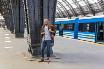 Man at subway using smartphone Free Photo