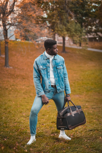 Man Carrying Brown Duffel Bag Man Carrying Brown Duffel Bag
