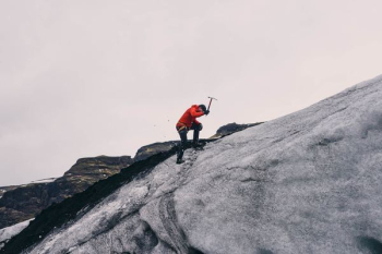 man climbing on mountain during daytime man climbing on mountain during daytime