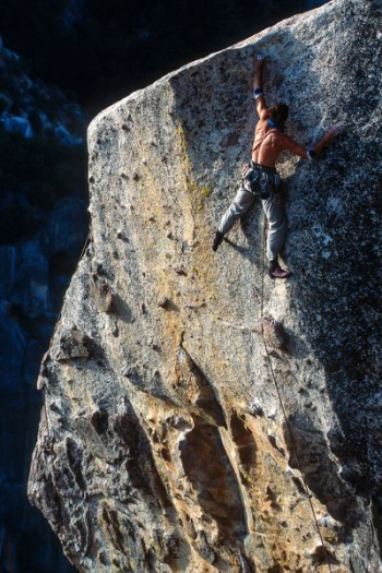 man climbing on rock hill during daytime man climbing on rock hill during daytime