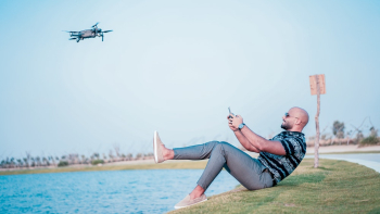 Man Controlling Quadcopter Drone Man Controlling Quadcopter Drone