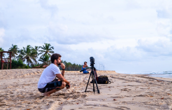 Man Crouching on Shore Man Crouching on Shore