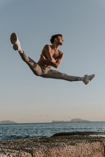 Man Doing Stunt Near Body of Water Man Doing Stunt Near Body of Water