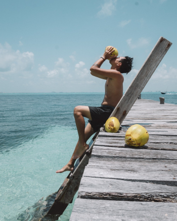 Man Drinking from Coconut Man Drinking from Coconut