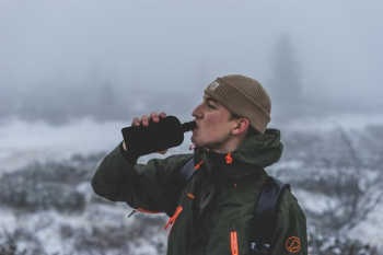 man drinking on flask man drinking on flask