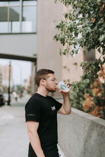 man drinking Starbucks coffee man drinking Starbucks coffee