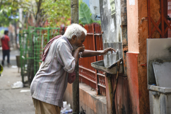 Man Drinking Water from Drinking Fountain