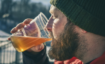 Man Drinking While Holding Plastic Cup Man Drinking While Holding Plastic Cup