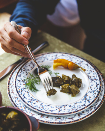 Man eats dolma with plain yougurt Free Photo Man eats dolma with plain yougurt Free Photo