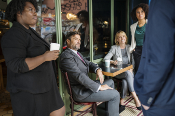 Man Facing Three Women and Man