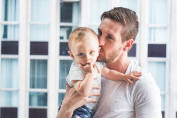 Man Holding and Kissing Baby Man Holding and Kissing Baby