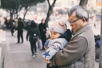 Man Holding Baby At Park Man Holding Baby At Park