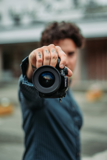 Man Holding Black Dslr Camera Man Holding Black Dslr Camera
