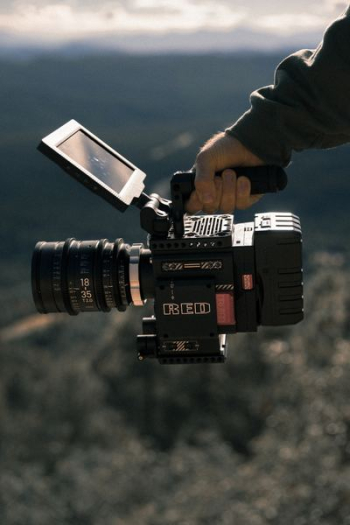 man holding black professional camcorder man holding black professional camcorder