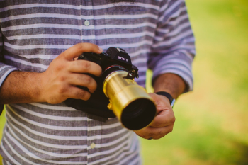 Man Holding Black Sony Camera Man Holding Black Sony Camera