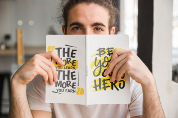 Man holding book cover mockup in front of face Free Psd