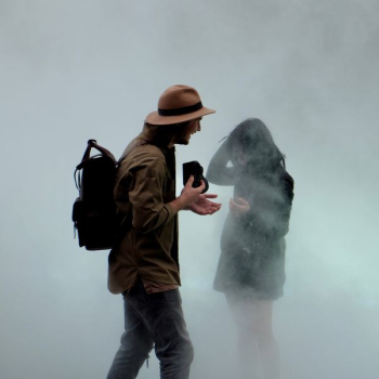 man holding camera in front of girl man holding camera in front of girl