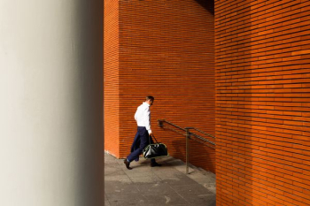 man holding duffel bag down stair man holding duffel bag down stair
