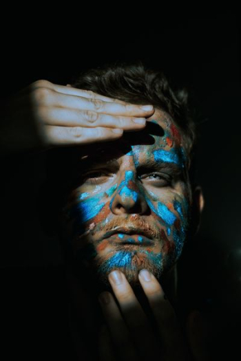man holding his face