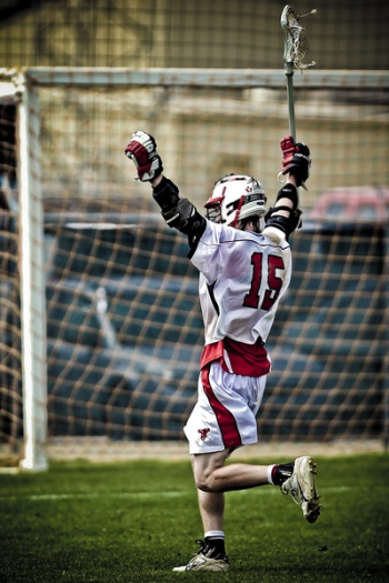 Man Holding Lacrosse Running Towards Goal Man Holding Lacrosse Running Towards Goal