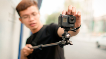 Man Holding Monopod With Action Camera Man Holding Monopod With Action Camera