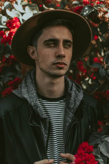 man holding red flowers man holding red flowers
