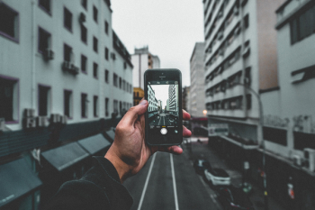 Man Holding Smartphone Capturing Roadway Man Holding Smartphone Capturing Roadway