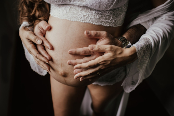 Man Holding Woman&#39;s Belly