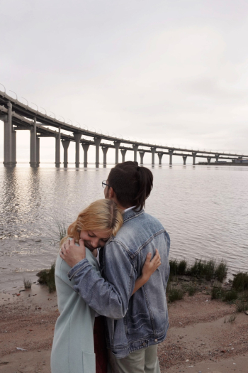 Man Hugging Woman Near Sea Man Hugging Woman Near Sea