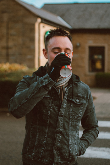 Man in Black Denim Jacket Drinking Man in Black Denim Jacket Drinking
