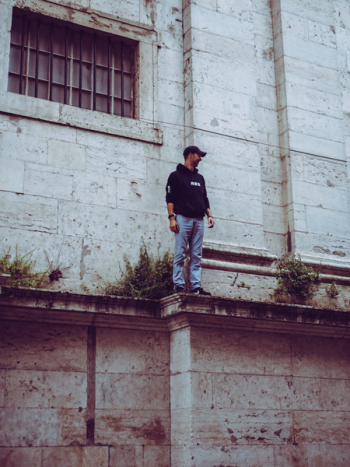 Man in Black Hooded Jacket Standing on Edge Man in Black Hooded Jacket Standing on Edge