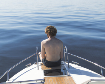 Man in Black Shorts on Boat End Man in Black Shorts on Boat End