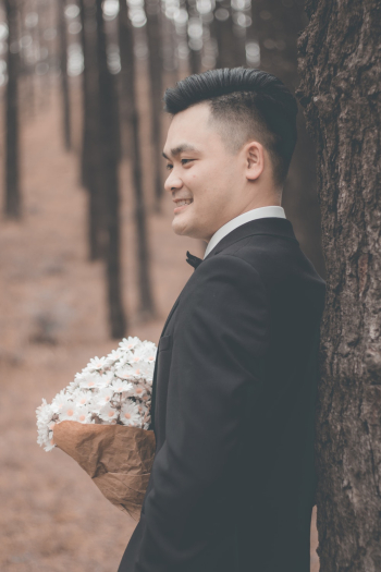 Man in Black Suit Holding Flowers Man in Black Suit Holding Flowers