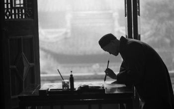 man in black suit holding pen man in black suit holding pen