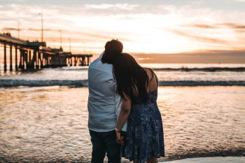 man in dress shirt beside woman in dress man in dress shirt beside woman in dress