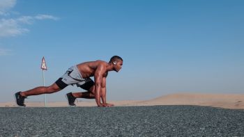 Man in Gray Shorts in Running Position Man in Gray Shorts in Running Position
