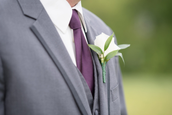 Man in Gray Suit Jacket and Calla Lily Boutonniere Man in Gray Suit Jacket and Calla Lily Boutonniere