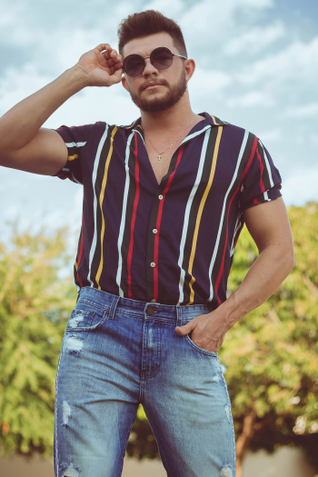 Man in Striped Shirt and Jeans Holding His Sunglasses Man in Striped Shirt and Jeans Holding His Sunglasses