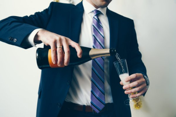 Man In Suit Celebrates With Champagne Man In Suit Celebrates With Champagne