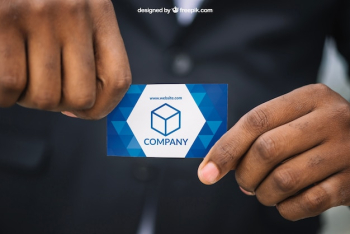 Man in suit holding business card mockup