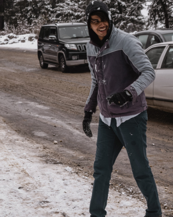 Man in Winter Jacket Laughing Near Cars Man in Winter Jacket Laughing Near Cars