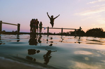man jump in mid air on body of water man jump in mid air on body of water