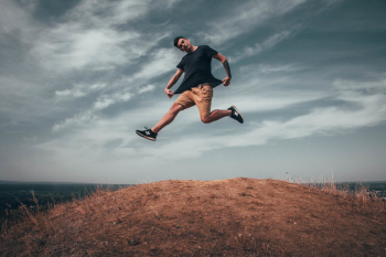 Man Jumping on Brown Soil Man Jumping on Brown Soil