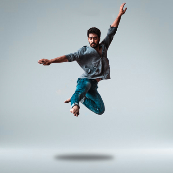 Man Jumping While Raising His Both Arms Man Jumping While Raising His Both Arms
