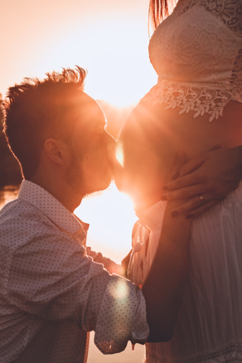 Man Kissing Woman's Belly Man Kissing Woman's Belly