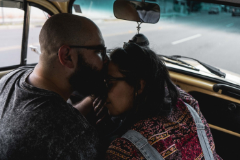 Man Kissing Woman Forehead Inside Car