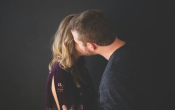 man kissing woman's cheek man kissing woman's cheek