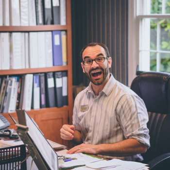 Man Laughing While Sitting on Office Chair Man Laughing While Sitting on Office Chair