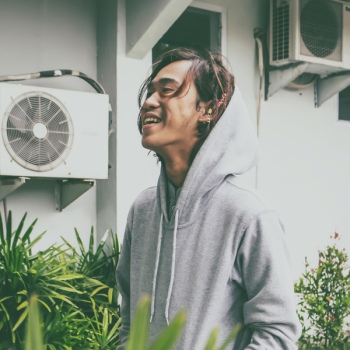 Man Laughing While Standing Near Plants Man Laughing While Standing Near Plants