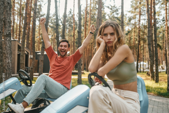 Man looking excited and the woman feeling upset after losing the competition Man looking excited and the woman feeling upset after losing the competition